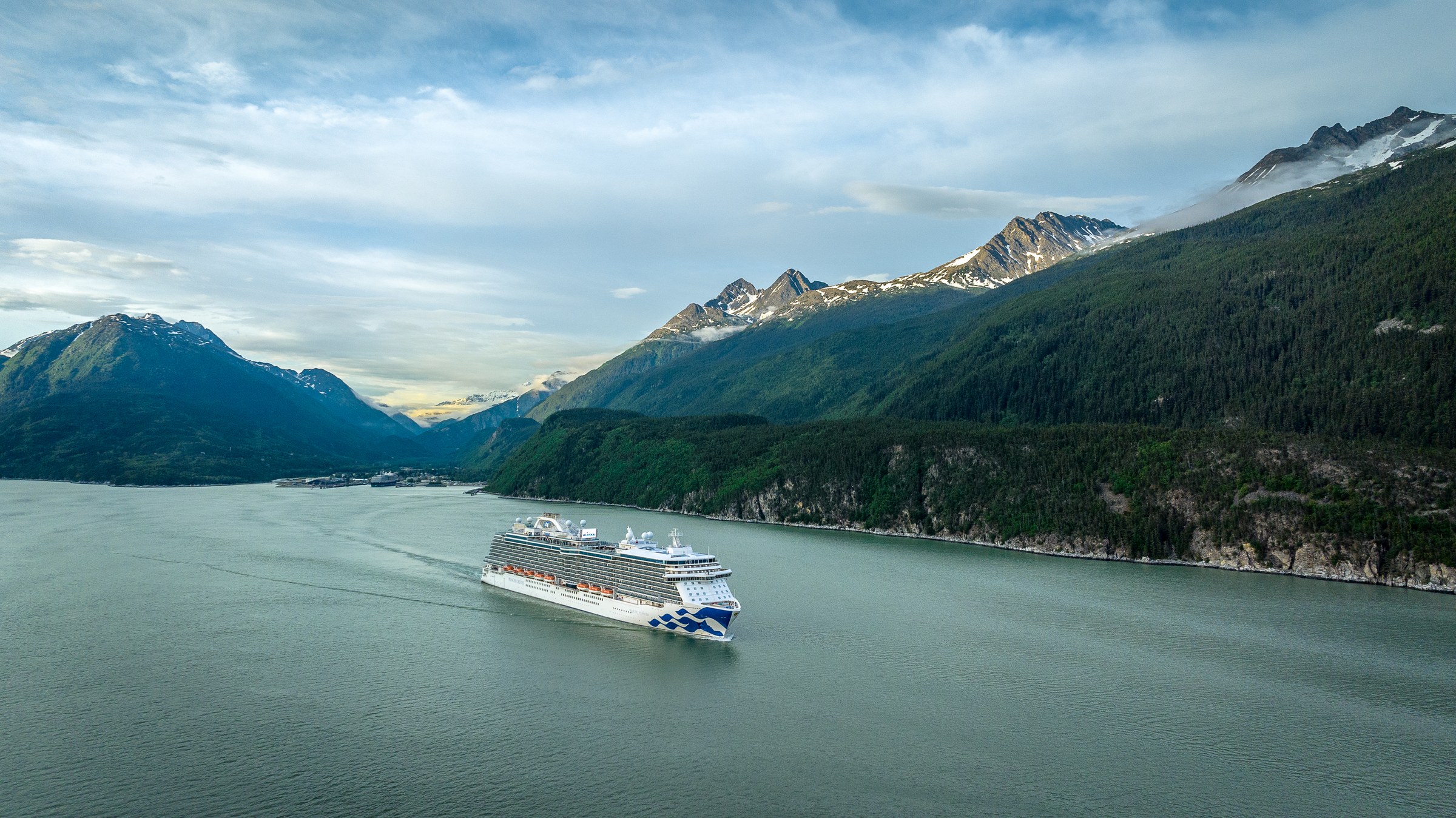 Majestic Princess sailing an Alaskan fjord under bright skies