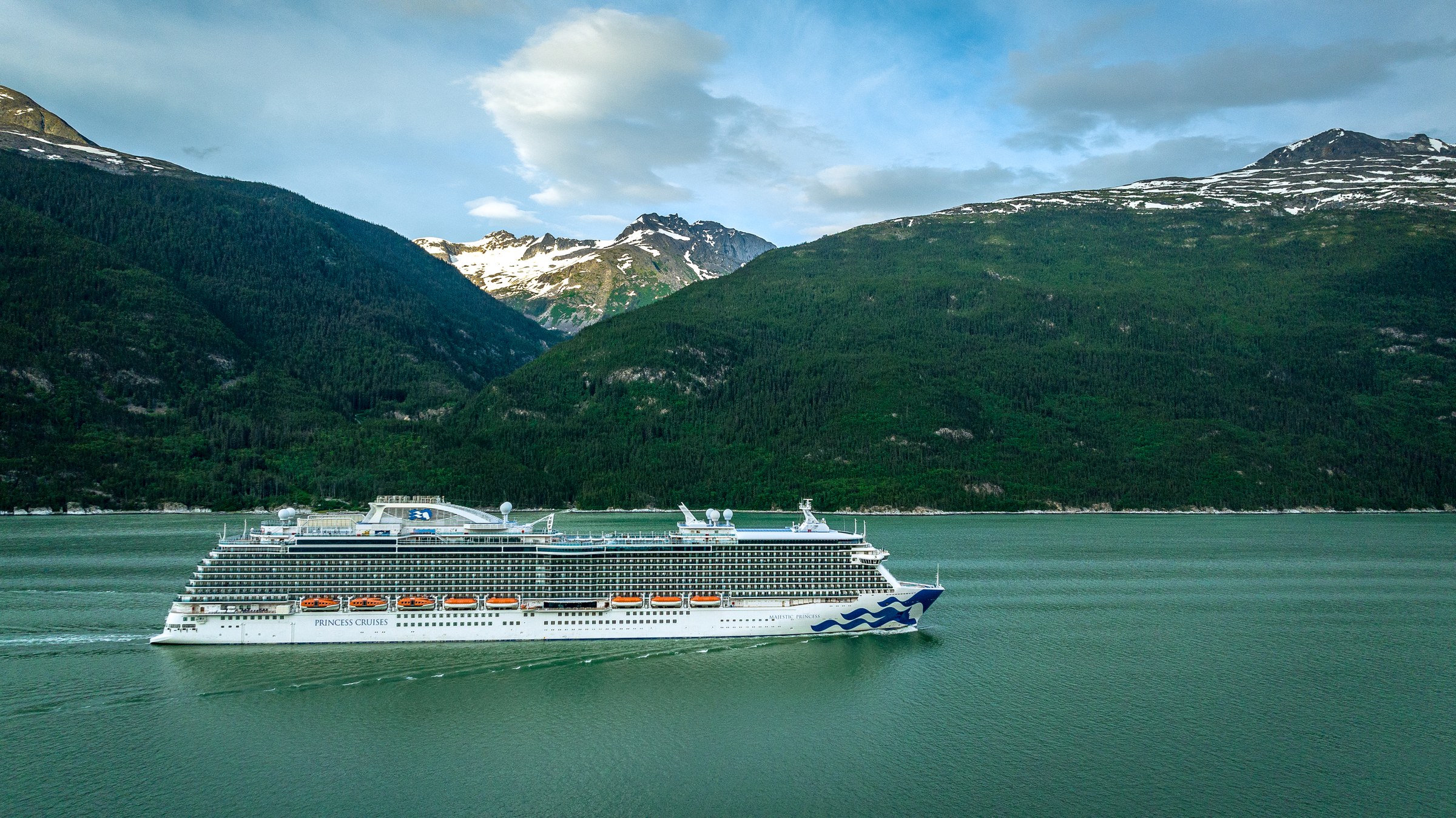 Majestic Princess full profile in an Alaskan fjord, ship name visible