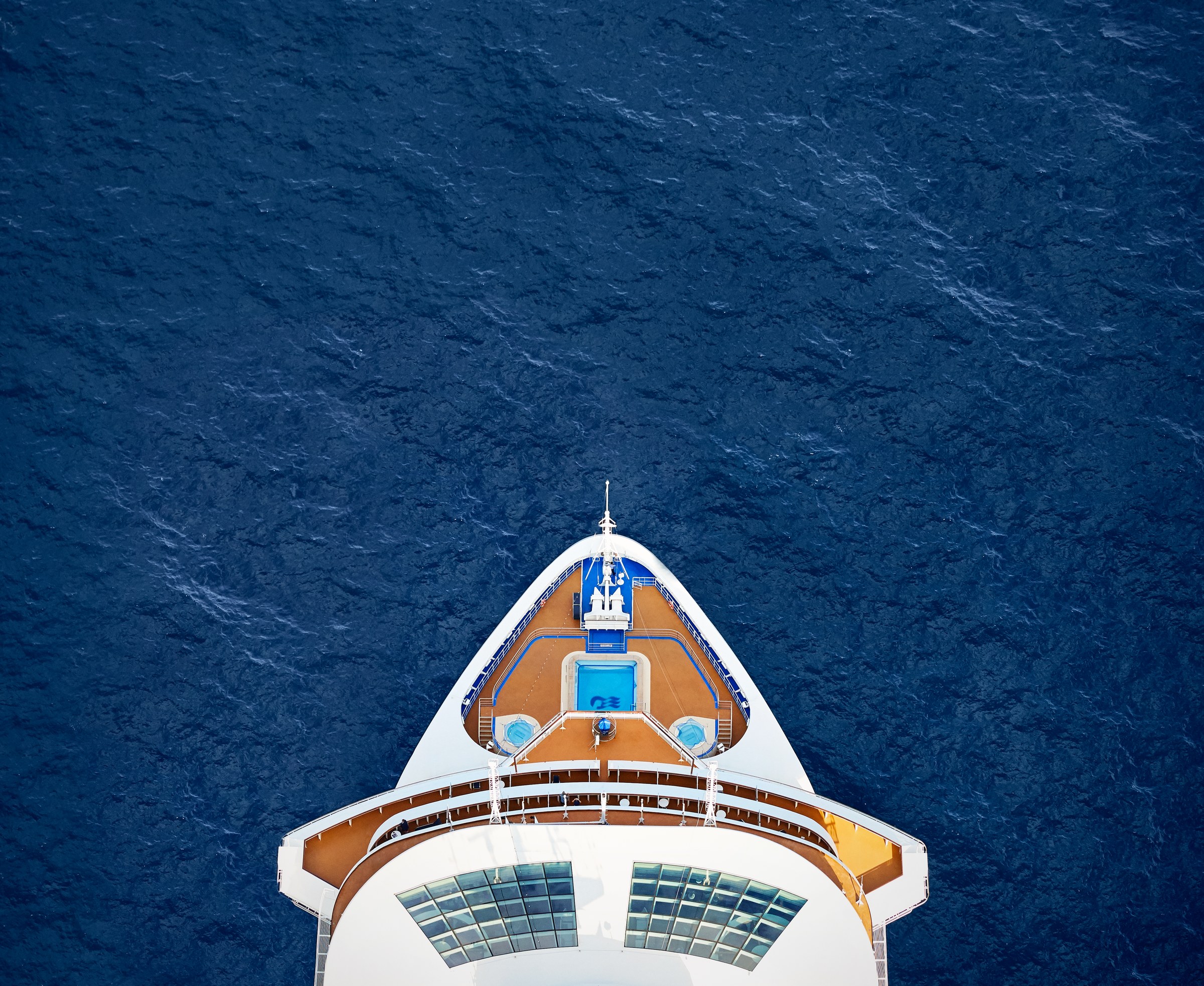 Overhead view of Majestic Princess bow pool cutting through deep blue water