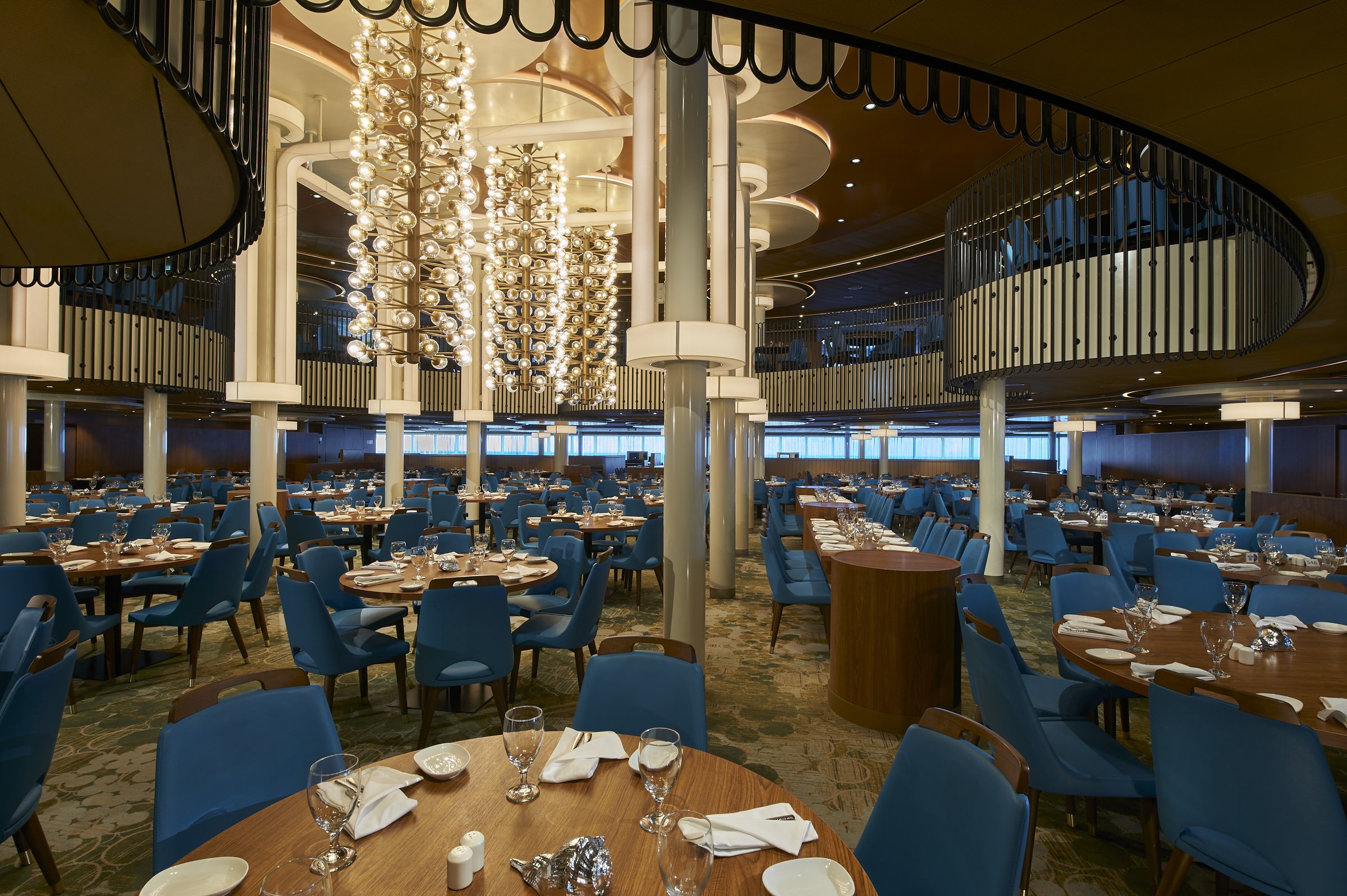 Mardi Gras two-level main dining room with glass chandeliers and blue chairs