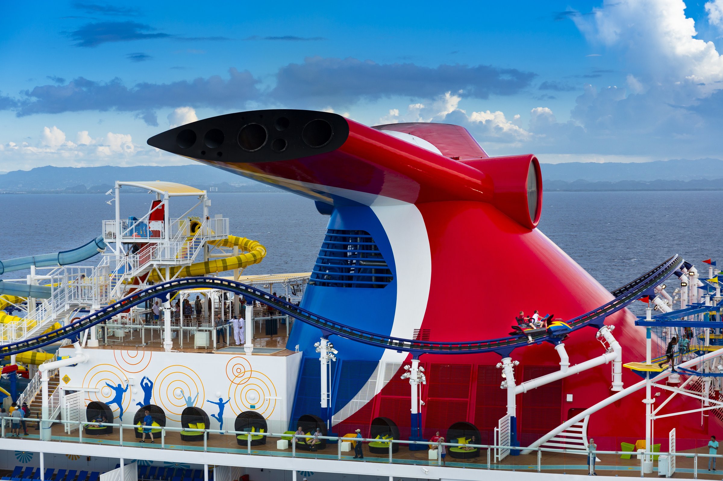 Mardi Gras red, white and blue funnel with the BOLT roller coaster track on a sunny day