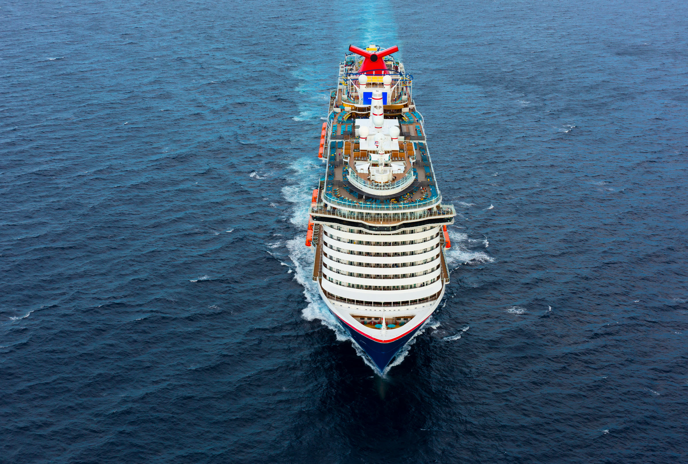 Mardi Gras bow aerial sailing open blue water in bright sun