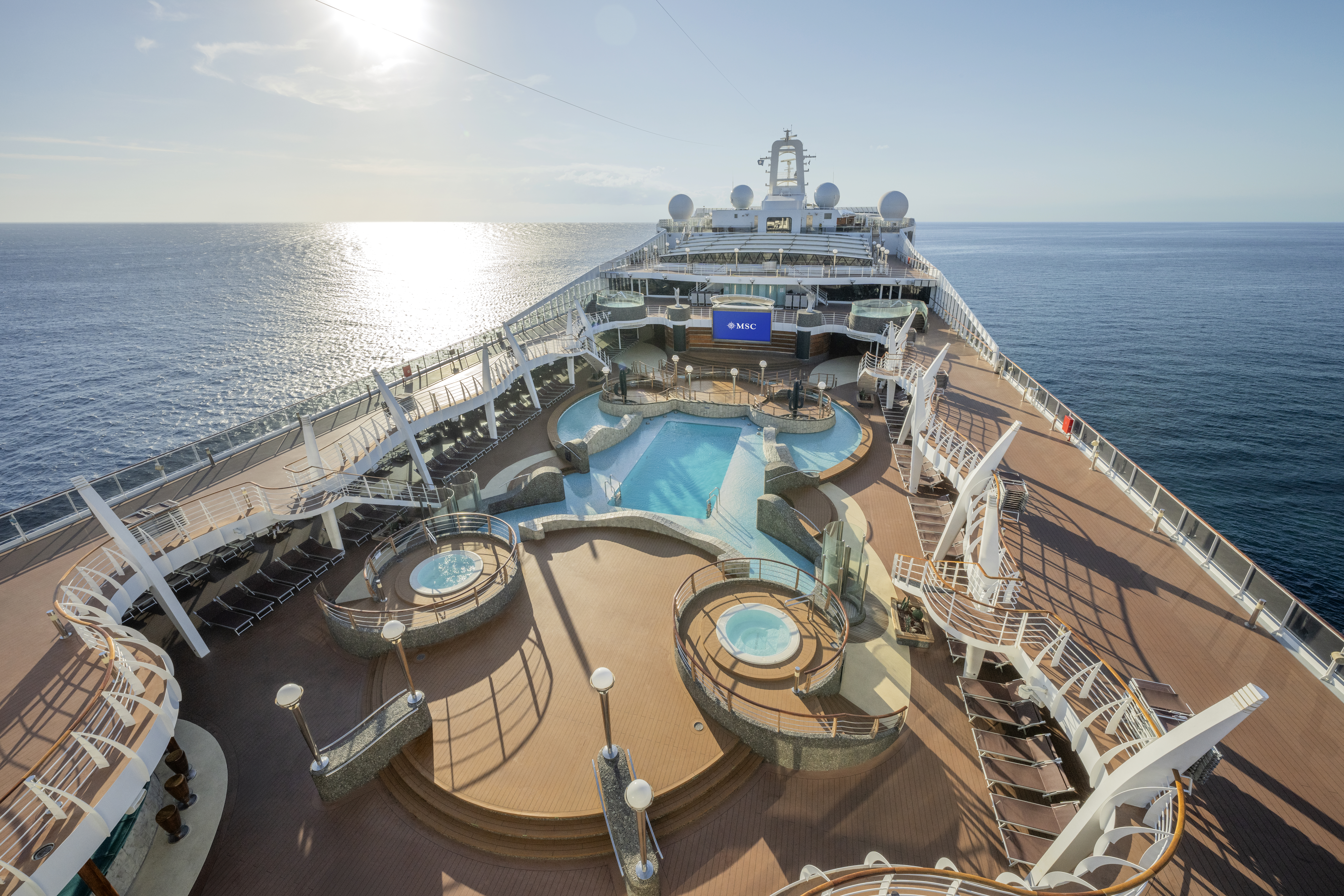 MSC Divina main pool deck with whirlpools under bright sun