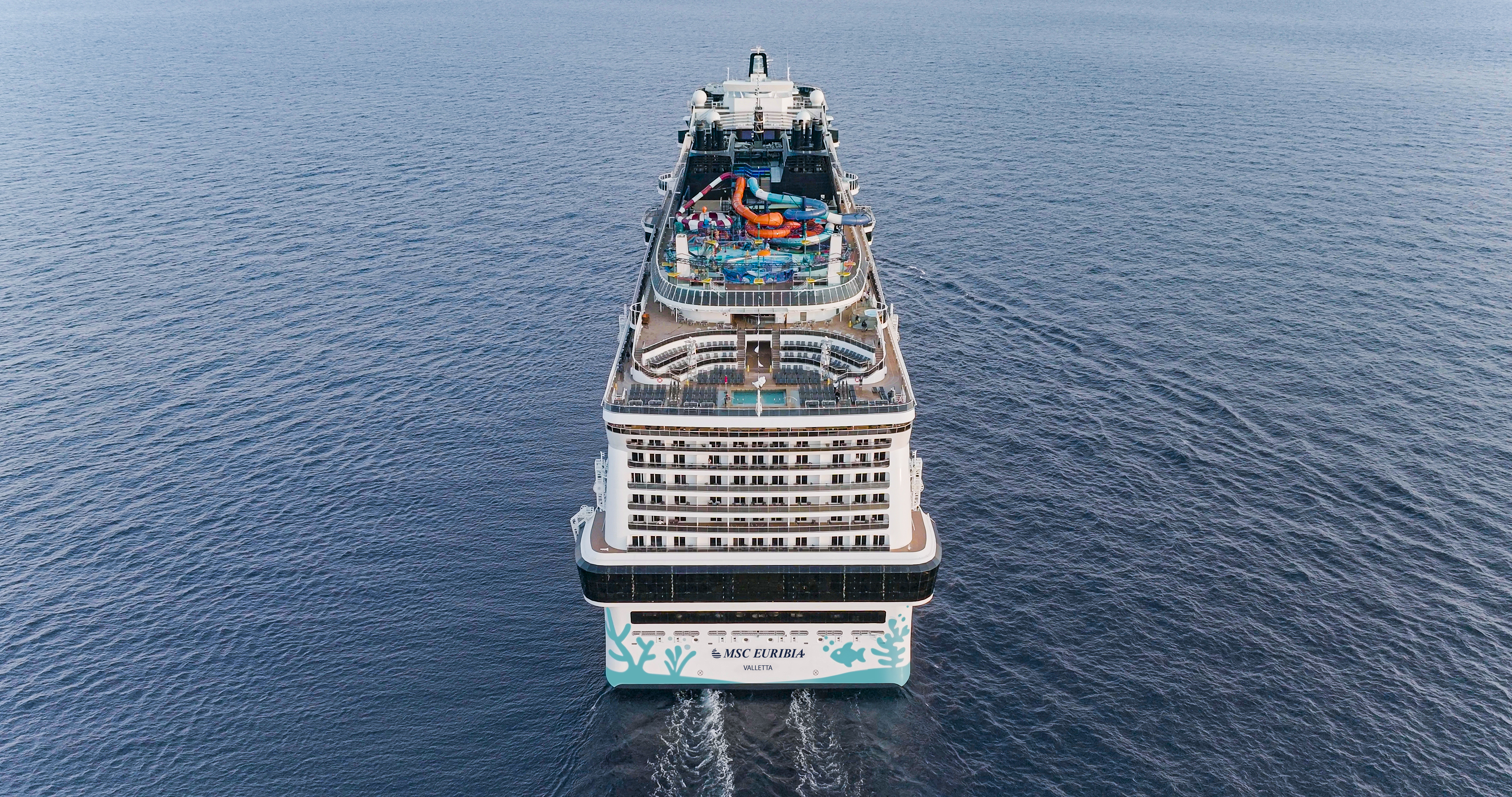 MSC Euribia stern aerial underway showing aquapark and coral hull art