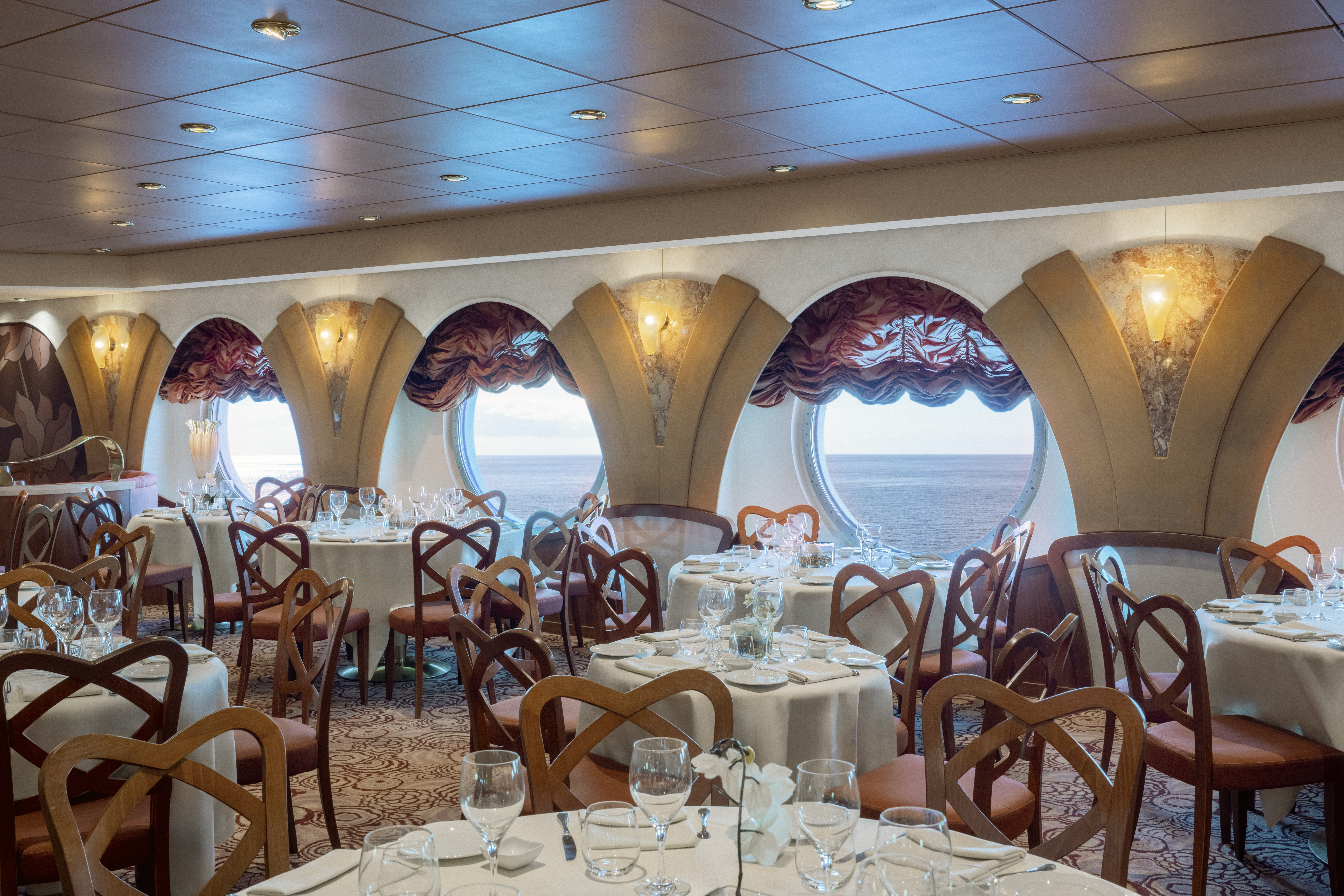 MSC Musica L’Oleandro restaurant dining room with porthole sea views
