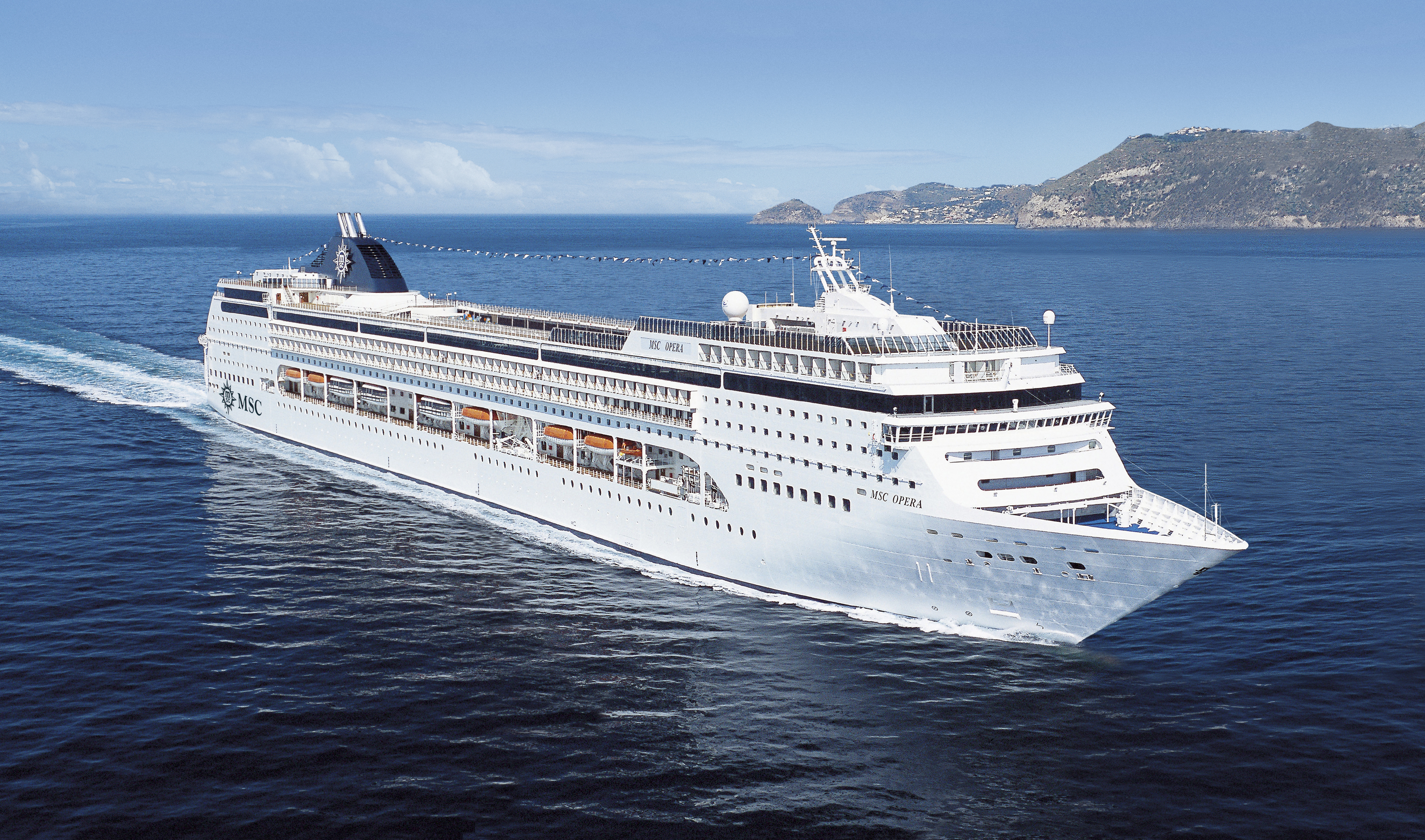 MSC Opera sailing at sea under clear midday sky