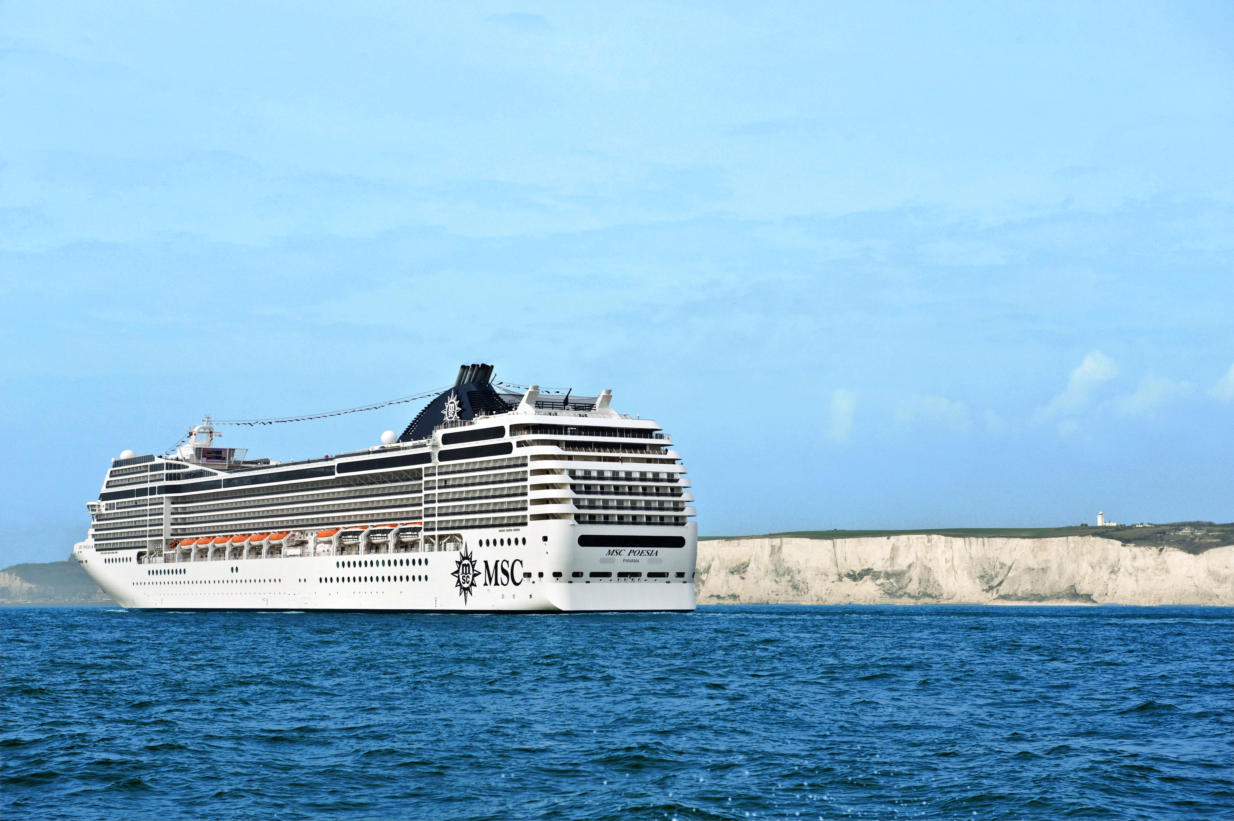 MSC Poesia sunny stern exterior at sea with White Cliffs behind