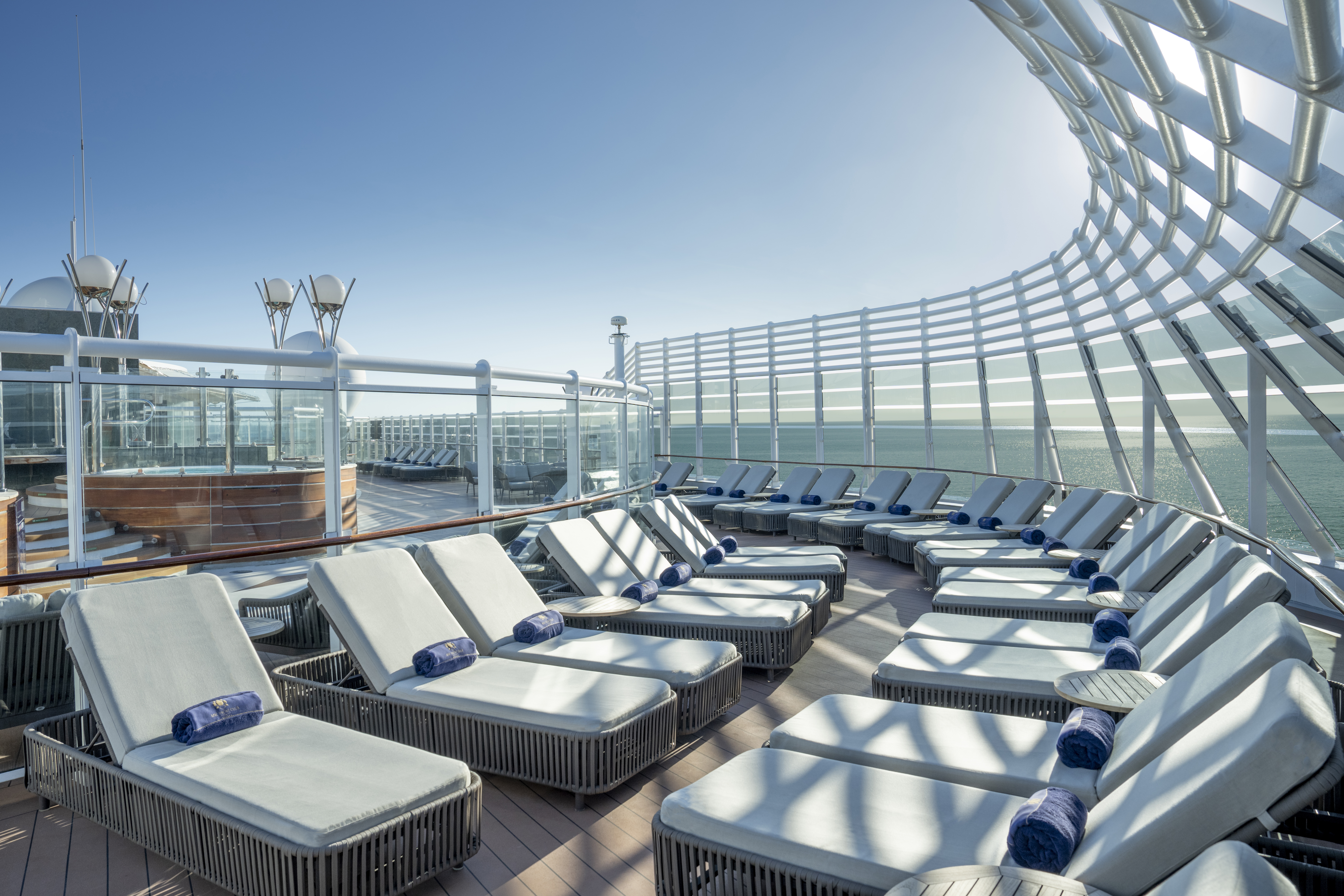 MSC Preziosa Yacht Club solarium loungers under bright sun