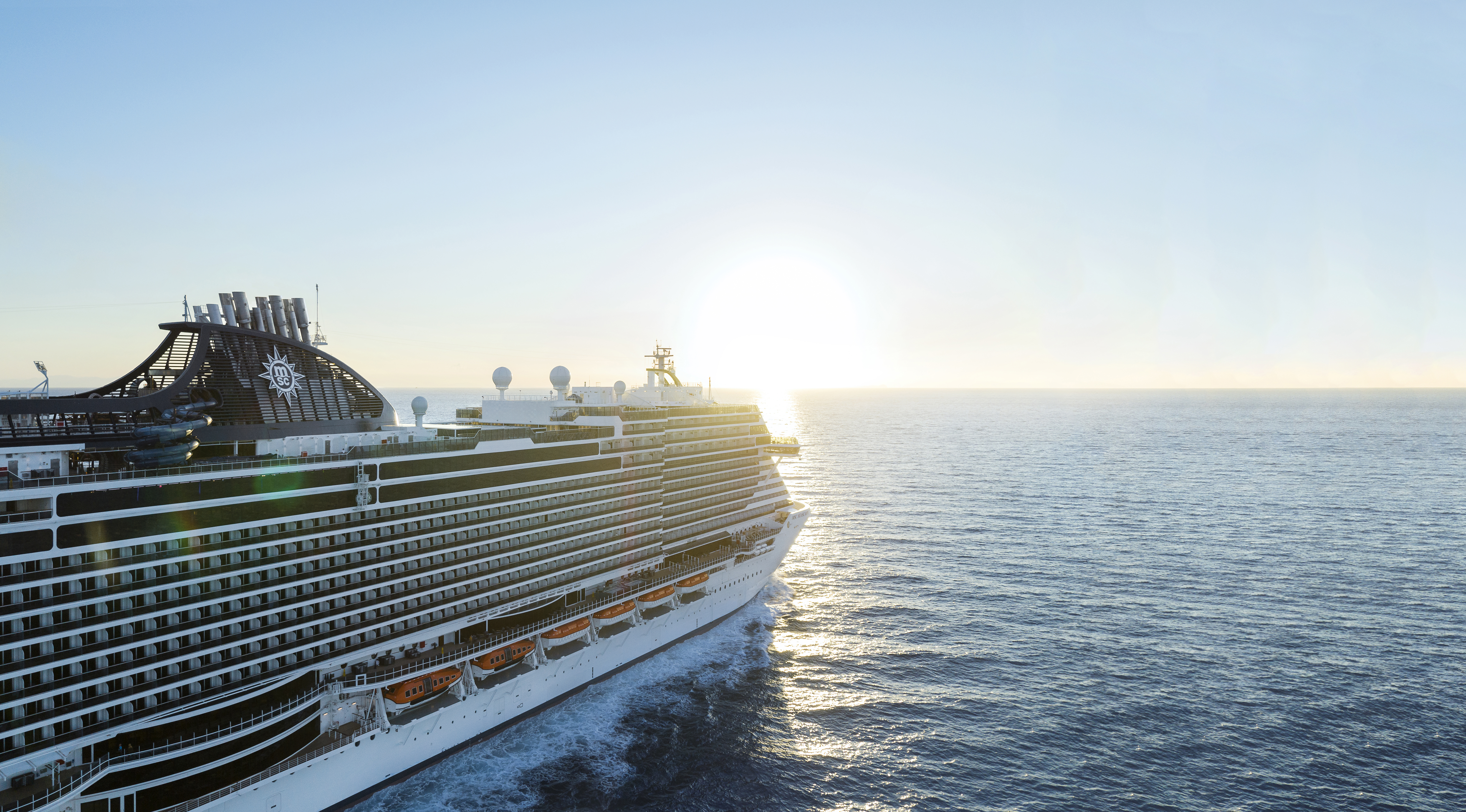 MSC Seascape aerial underway with sun on the horizon