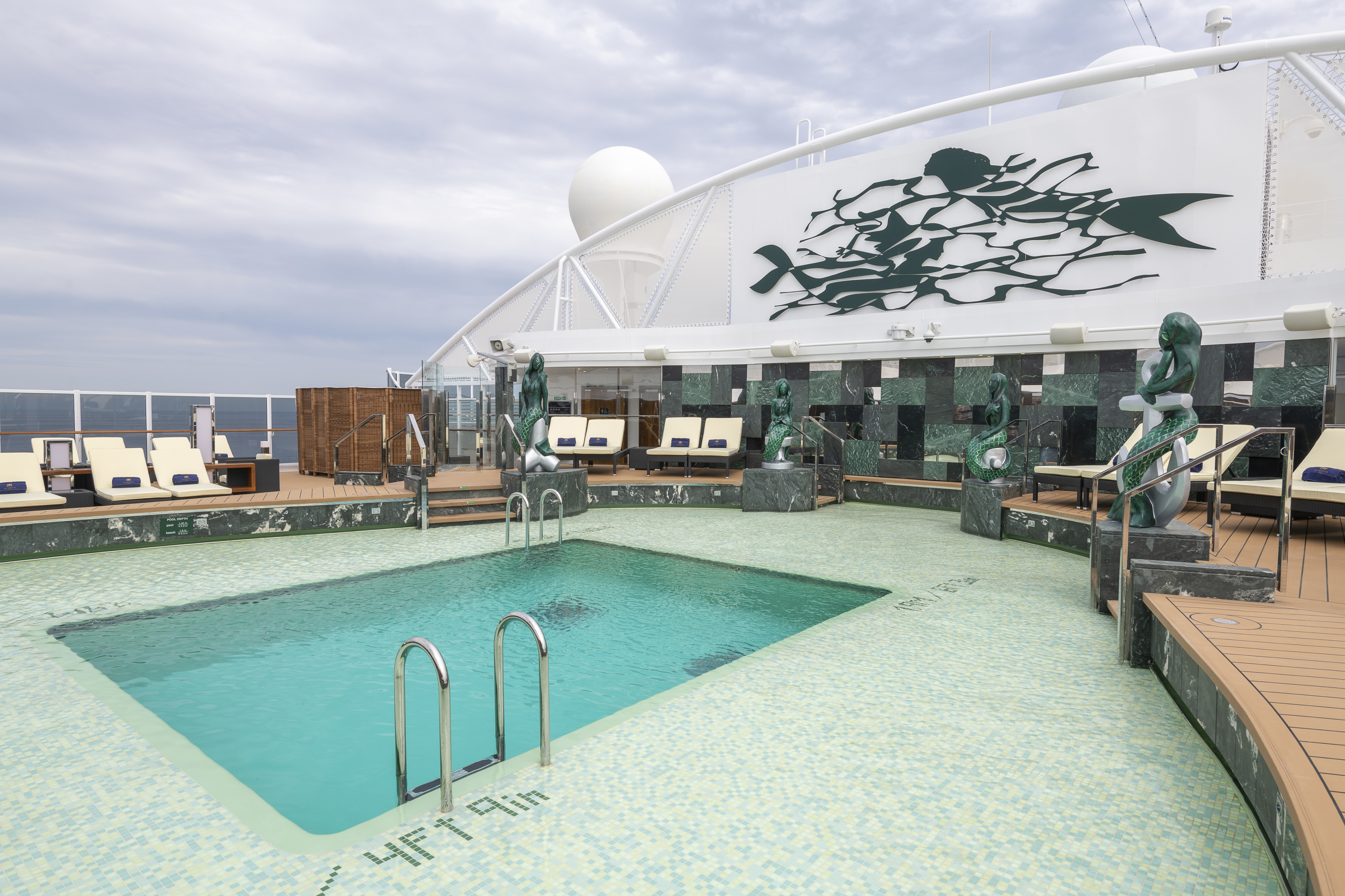 MSC Seaview Yacht Club pool with mermaid sculptures