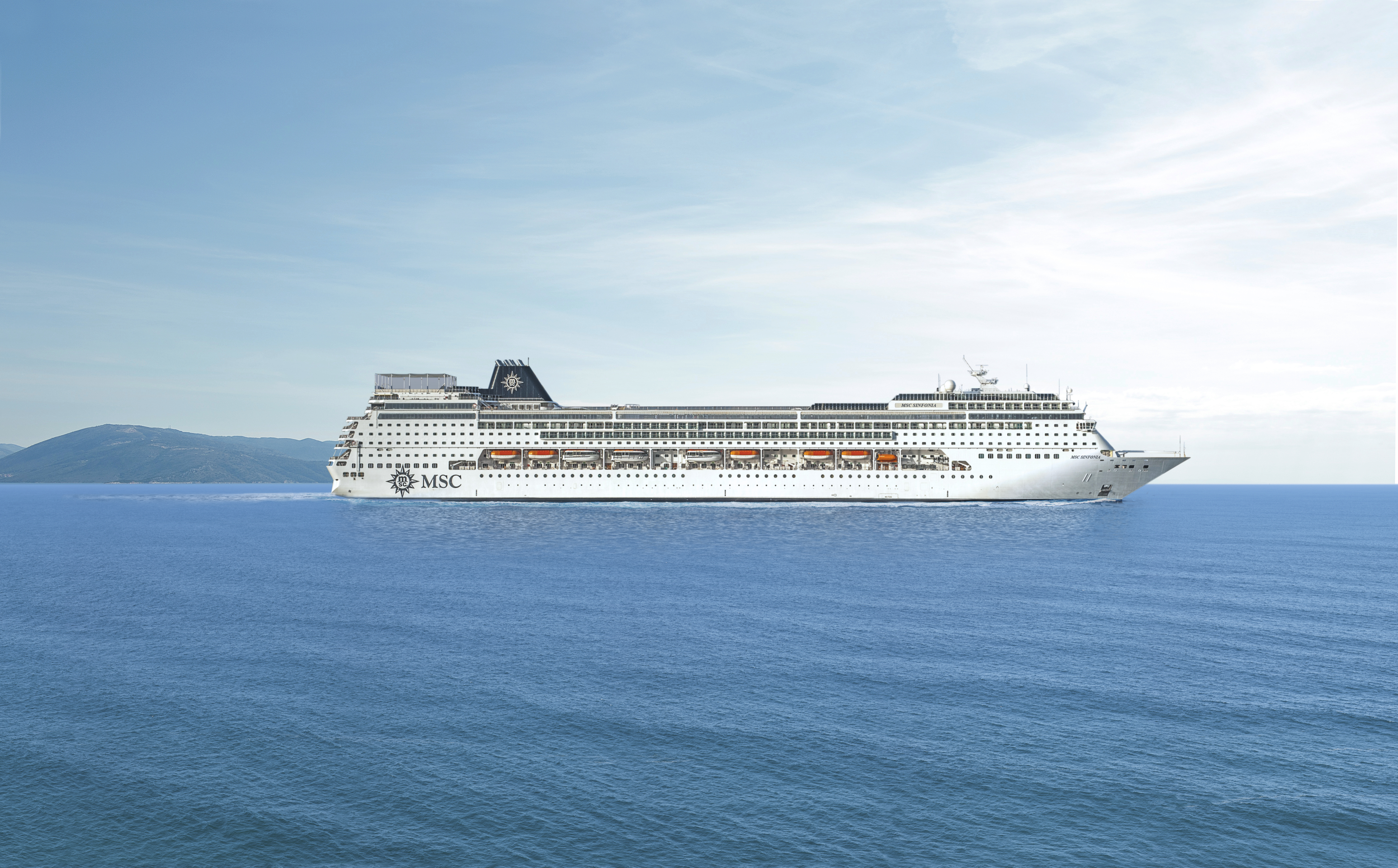 MSC Sinfonia sailing at sea under clear midday sky