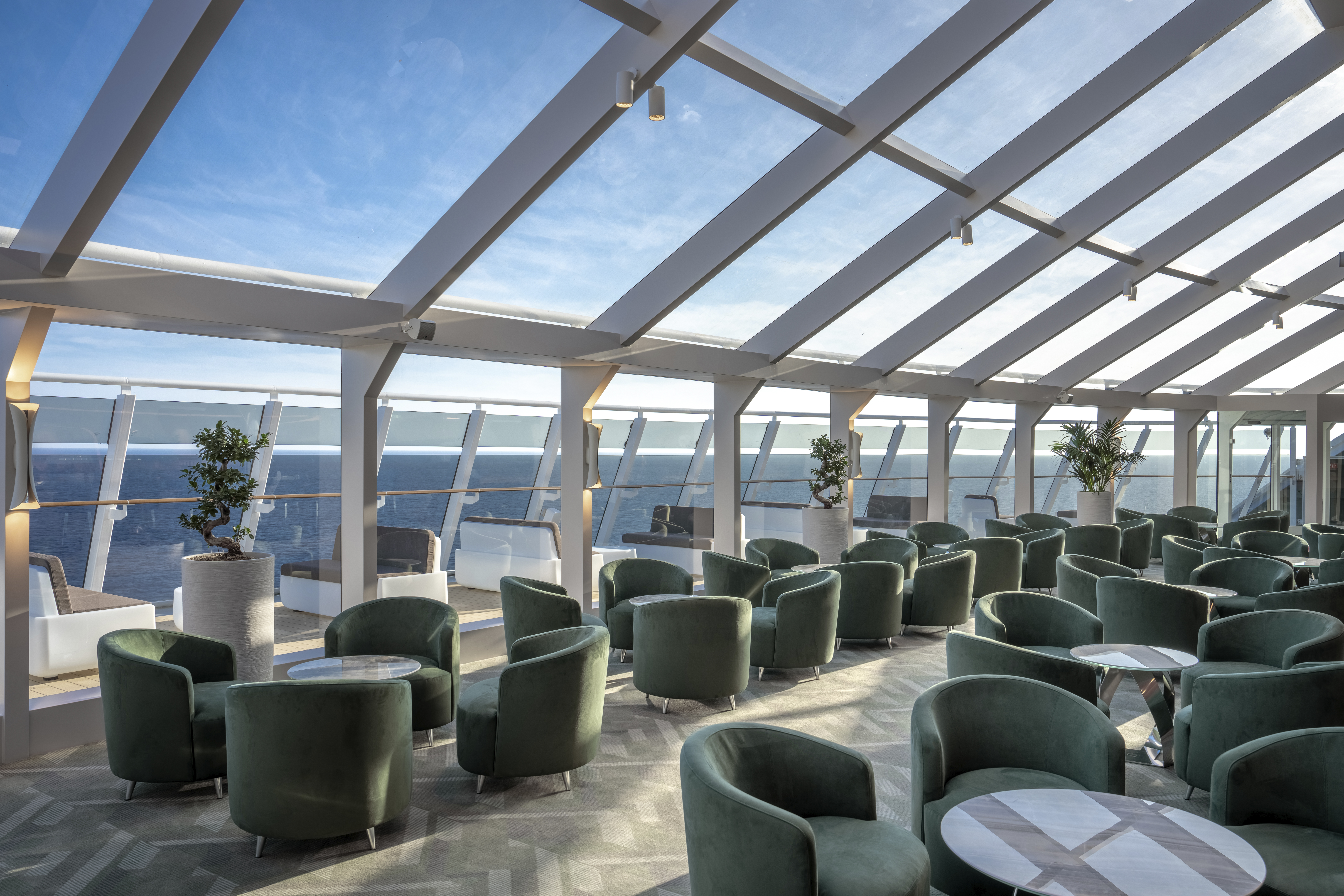 MSC World Asia Top Sail Lounge glass-walled Yacht Club lounge overlooking the sea