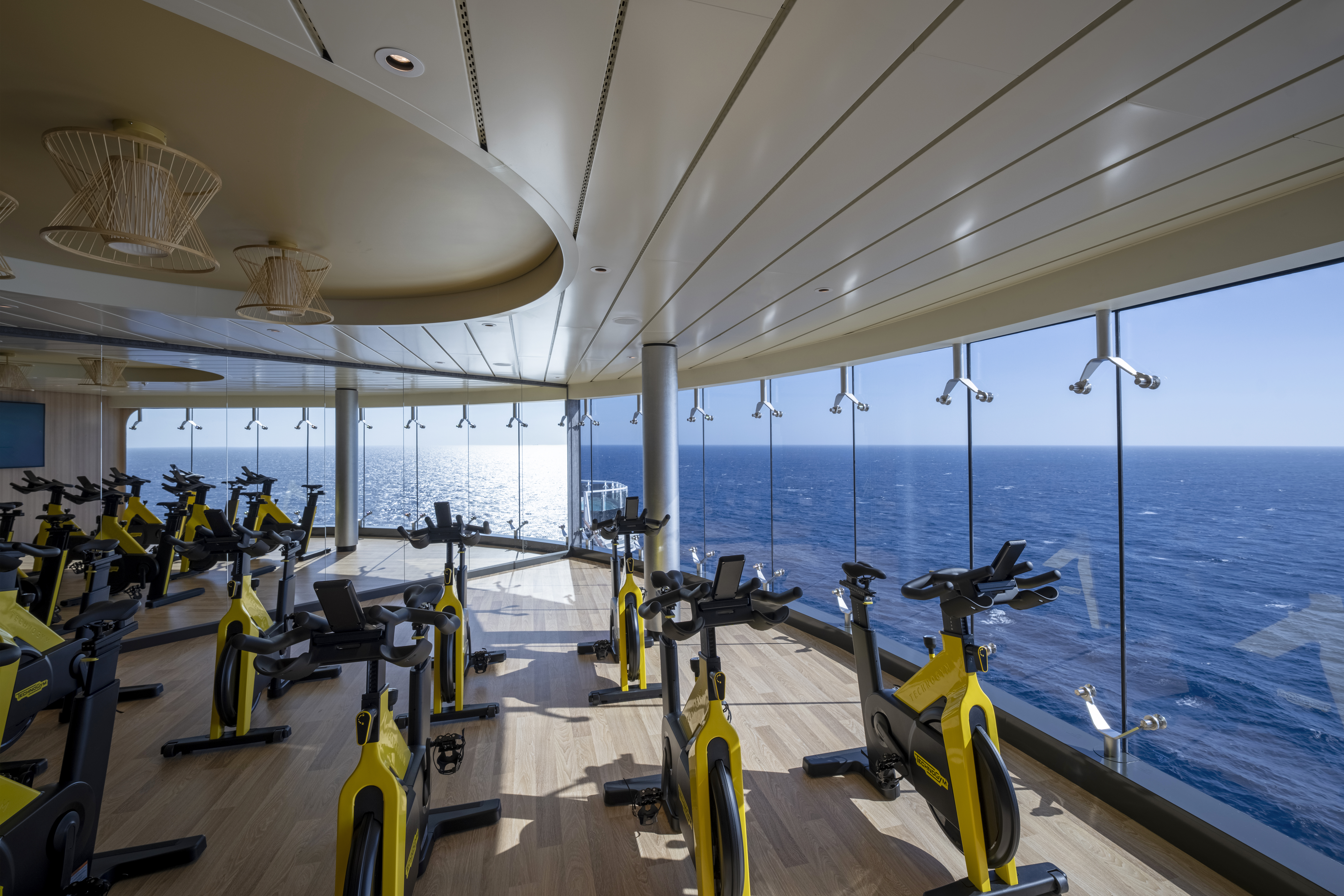 MSC World Asia sea-view gym with floor-to-ceiling ocean windows