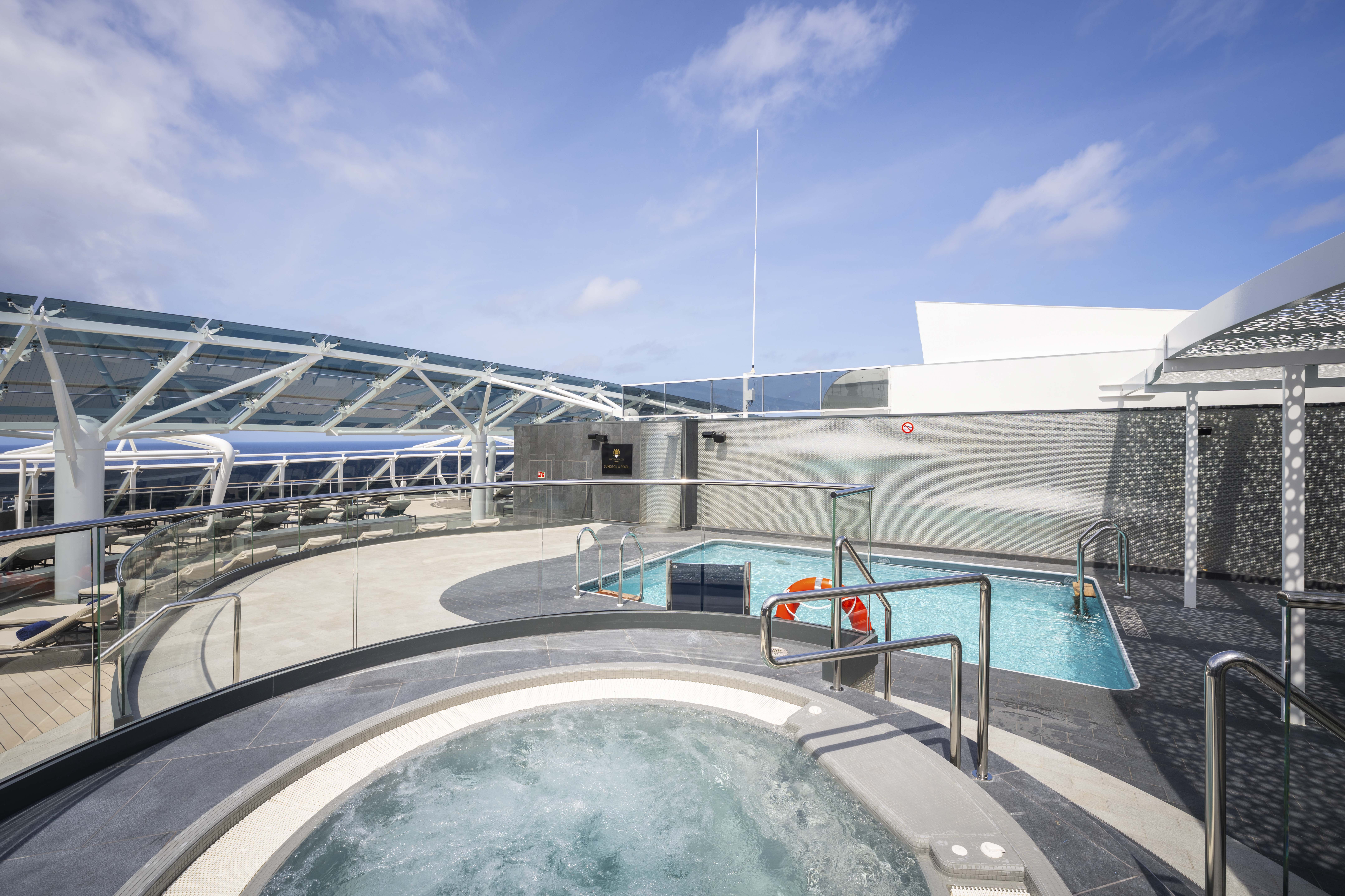MSC World Atlantic Yacht Club sundeck pool and whirlpool in bright sun