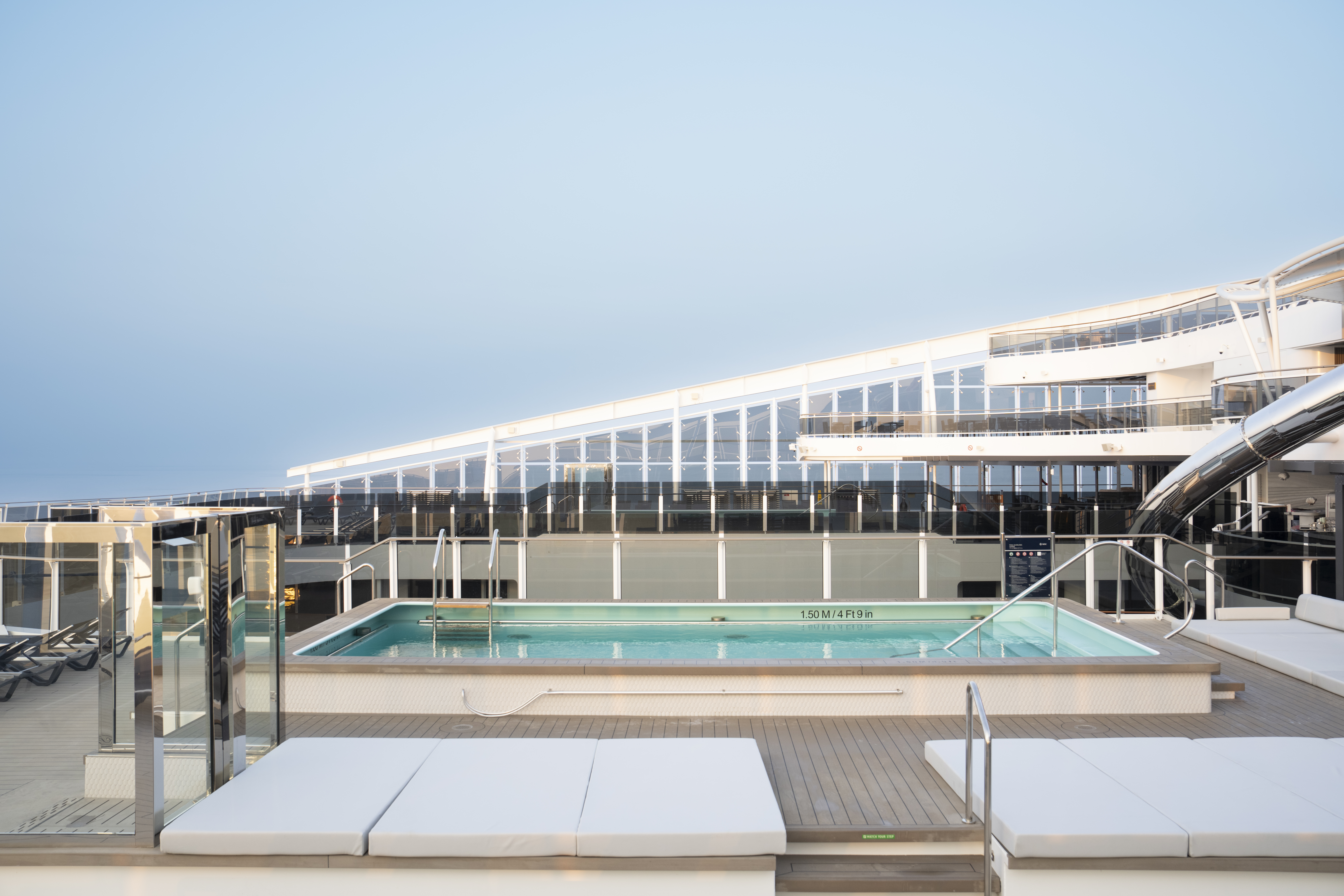 MSC World Europa Zen Pool with white sunpads on a bright day