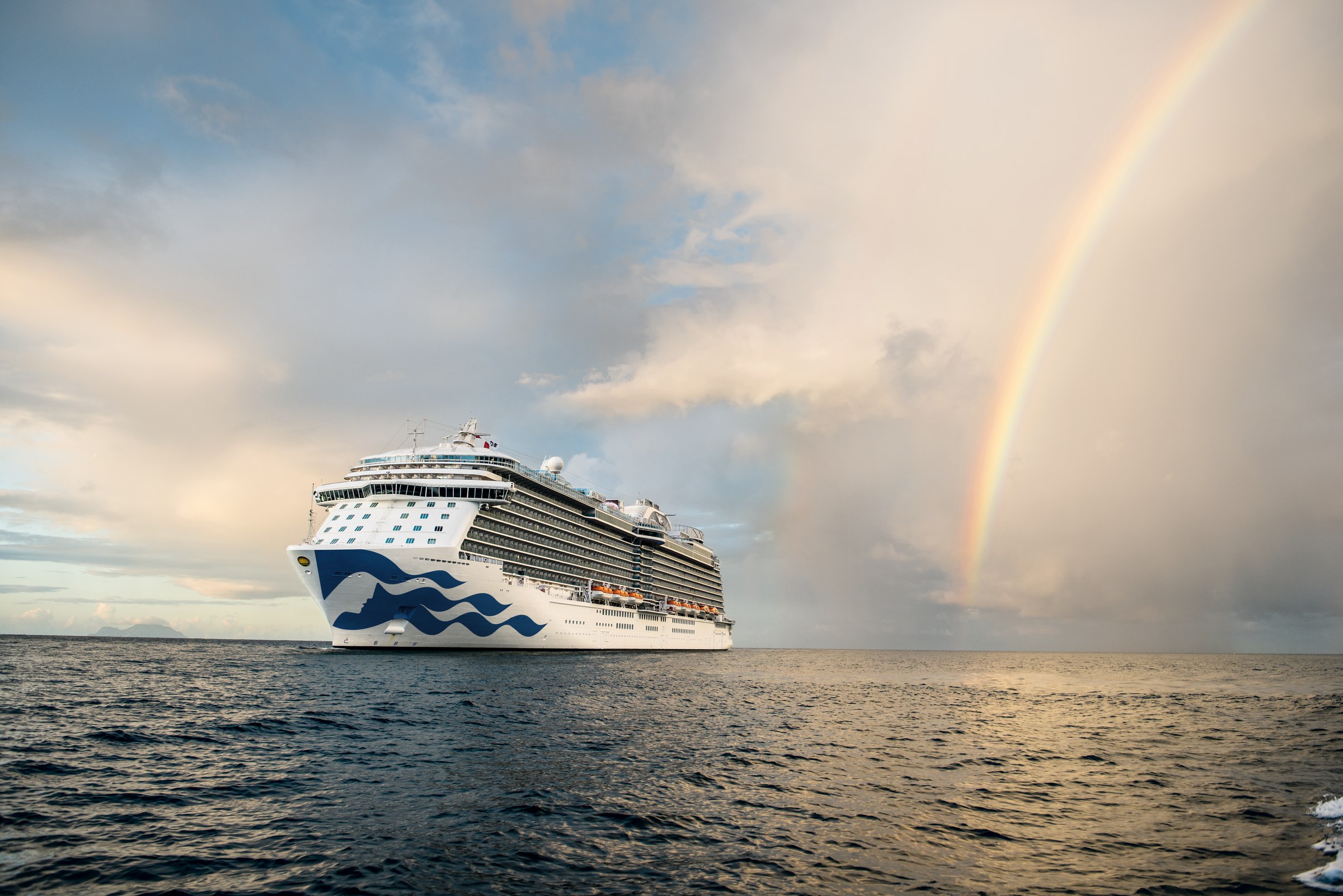 Royal Princess at sea under a bright rainbow