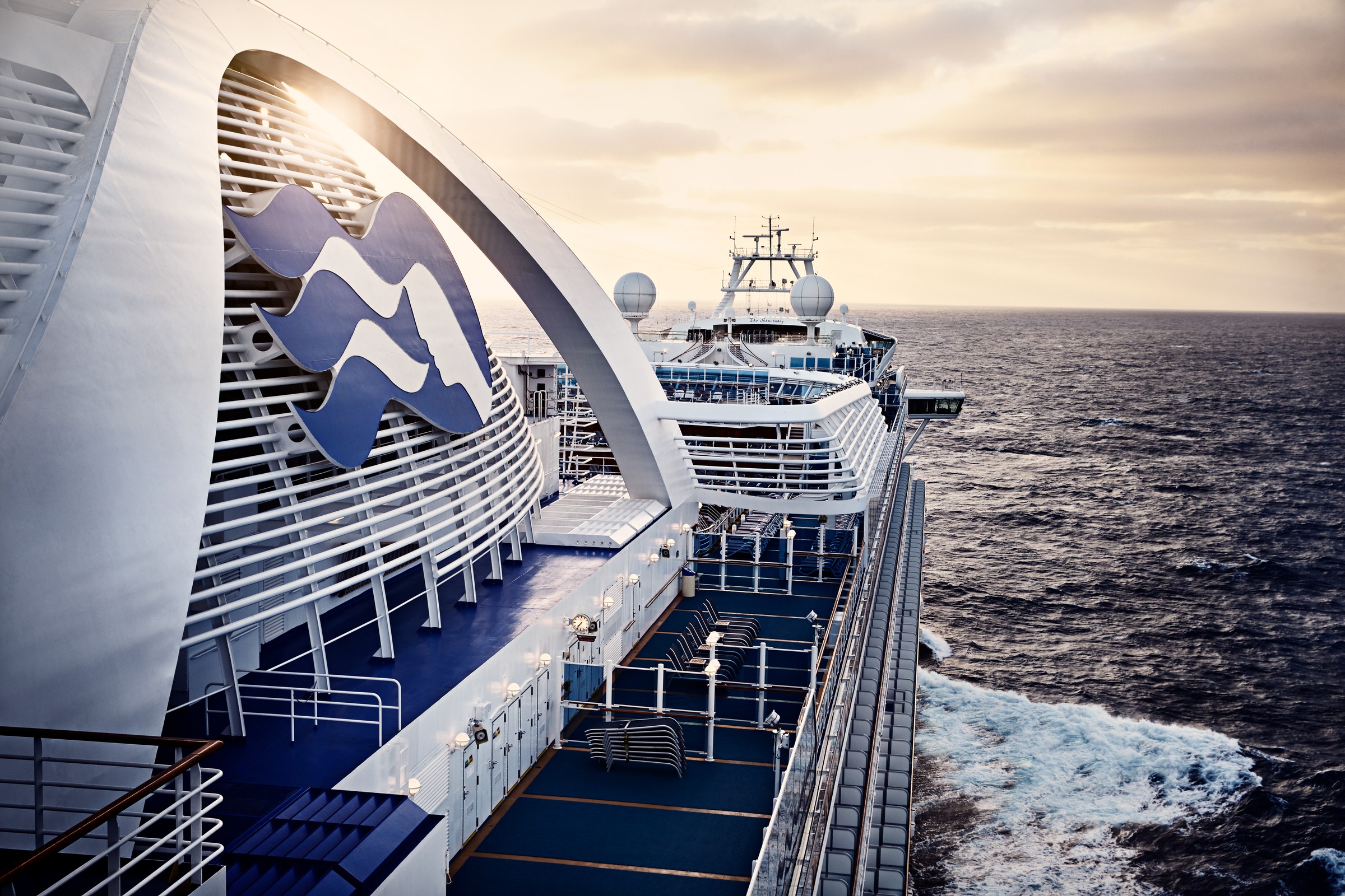 Ruby Princess at sunrise with wake trailing on open ocean