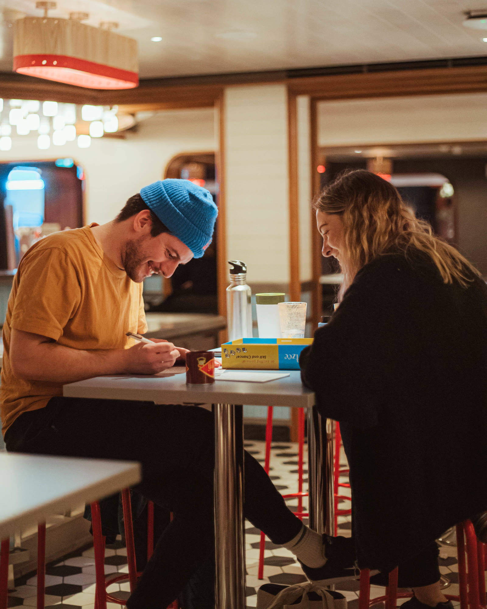 Couple playing a board game in The Social Club.