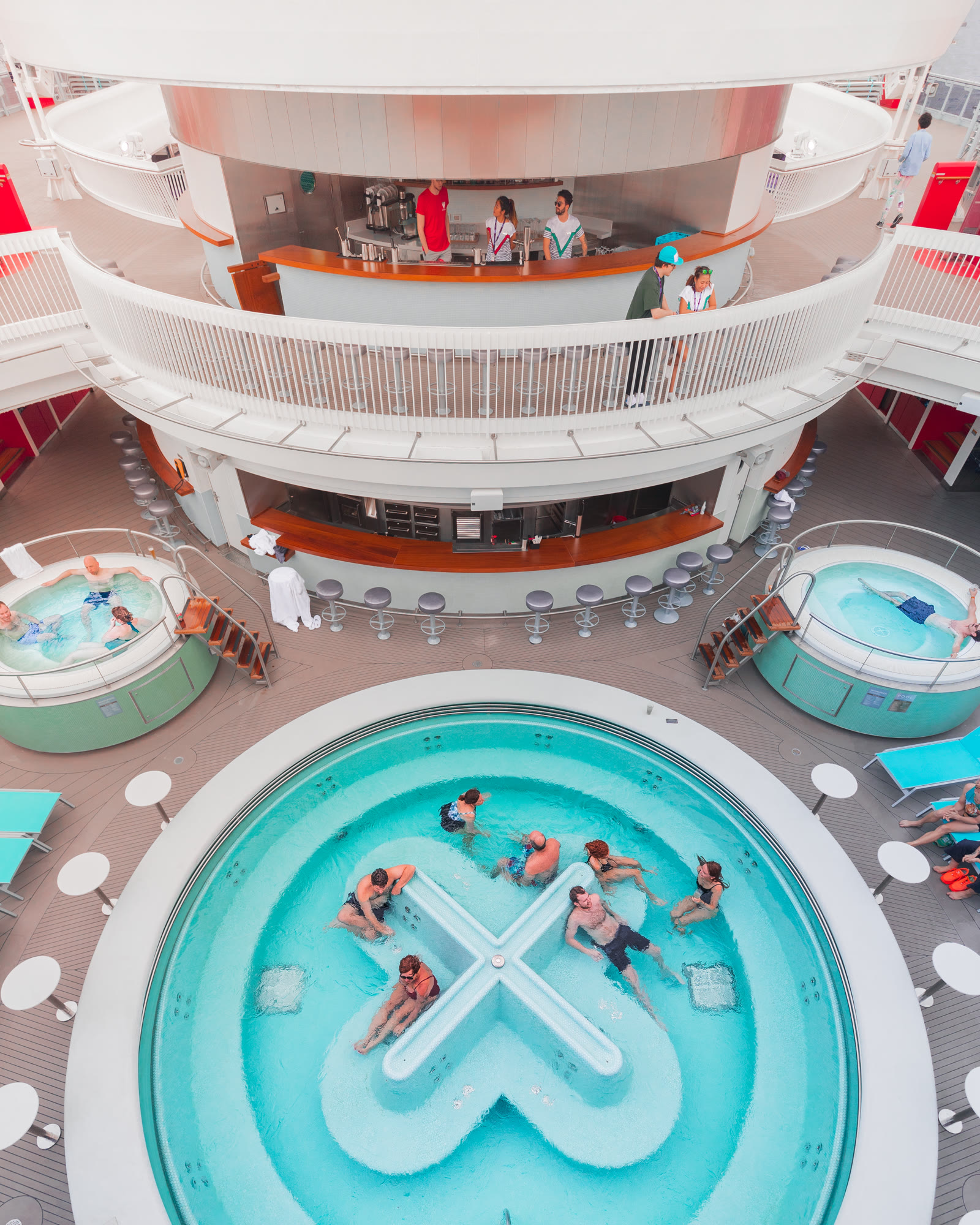 Overhead shot of people enjoying the wellbeing pool and hot tubs.