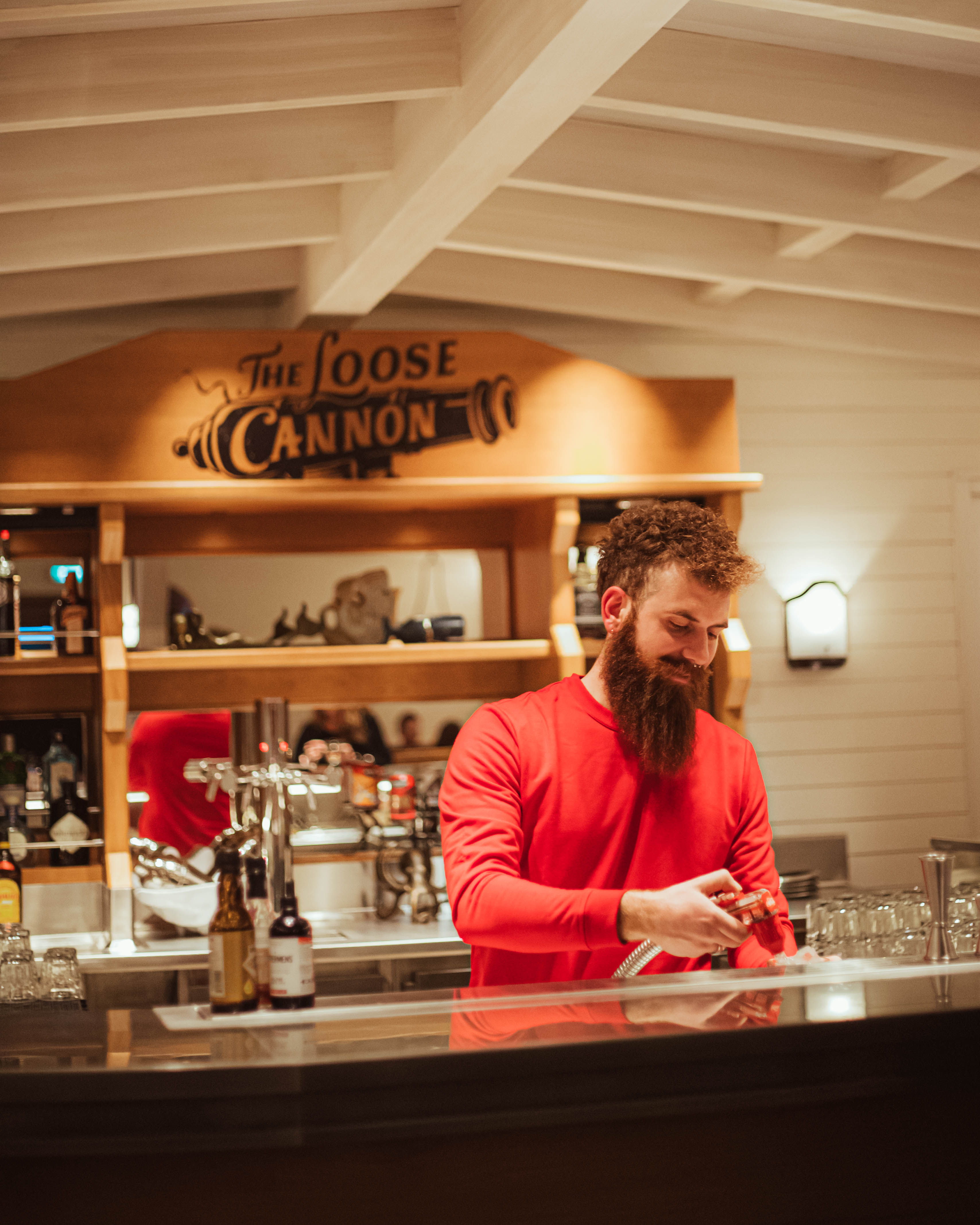 Bartender at The Loose Cannon bar in bright light.