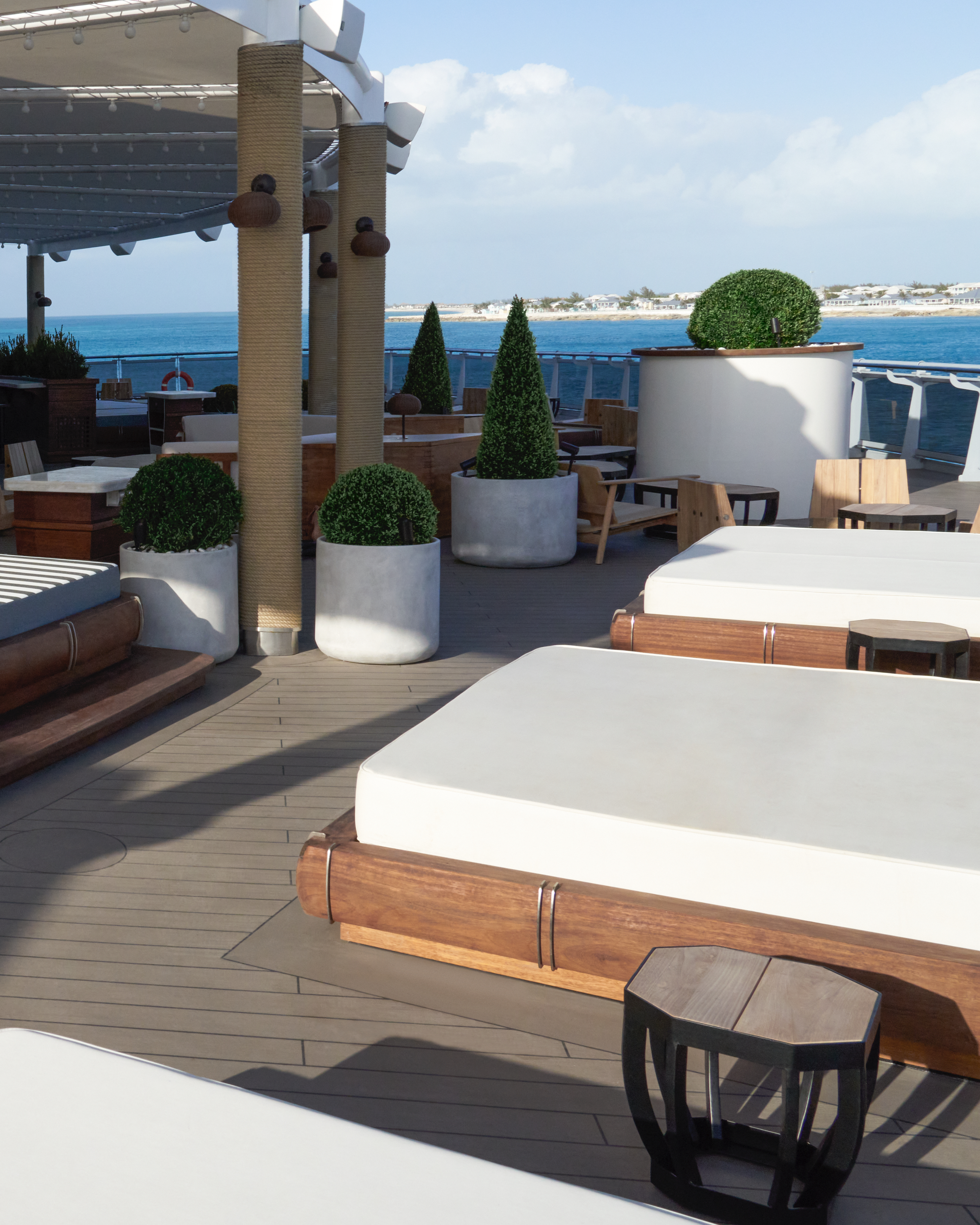The Dock outdoor daybeds overlooking blue ocean.
